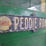 Old road sign on workshop door